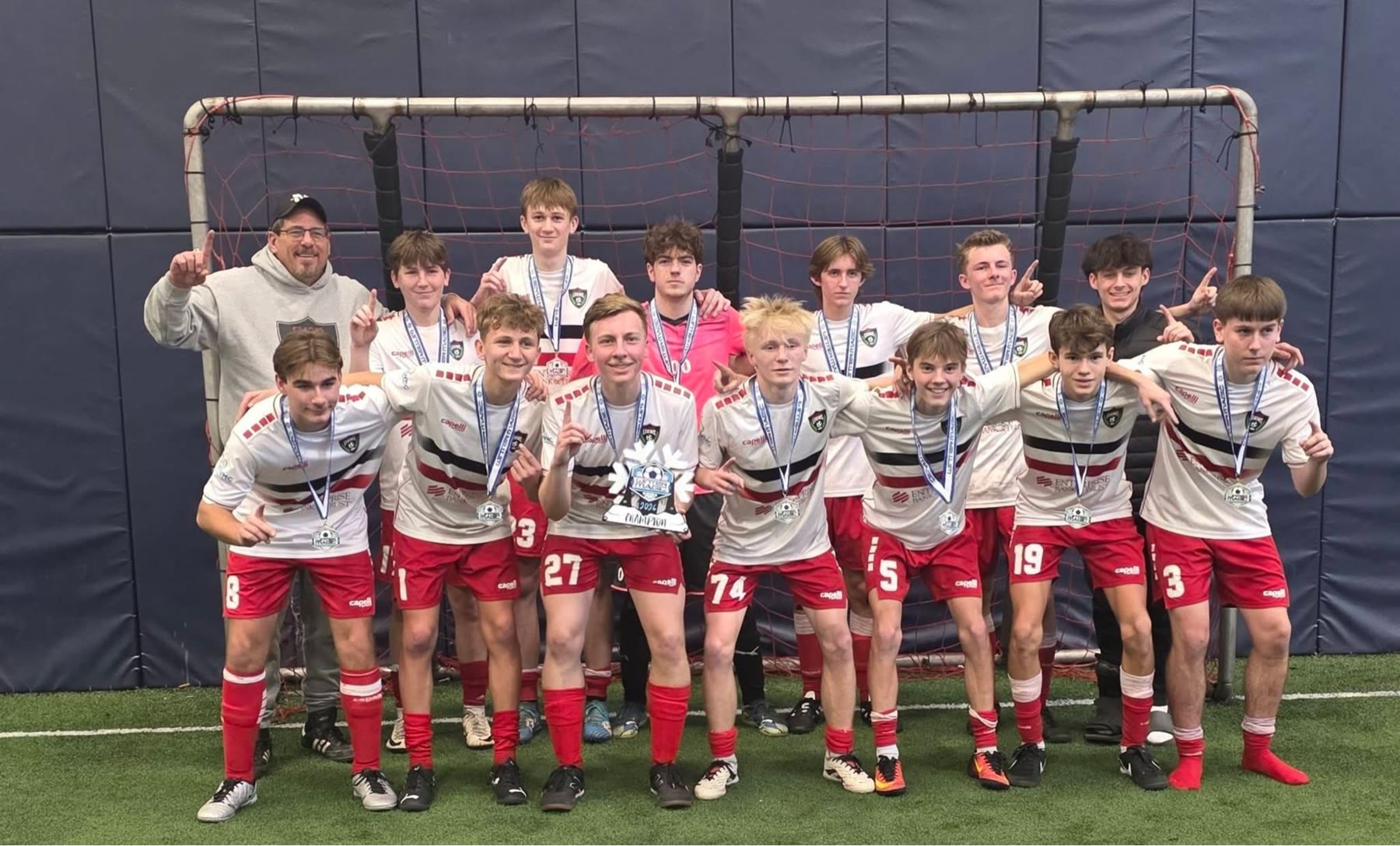 Scott Gaither with a St. Louis Legends boys team celebrating with medals after a tournament