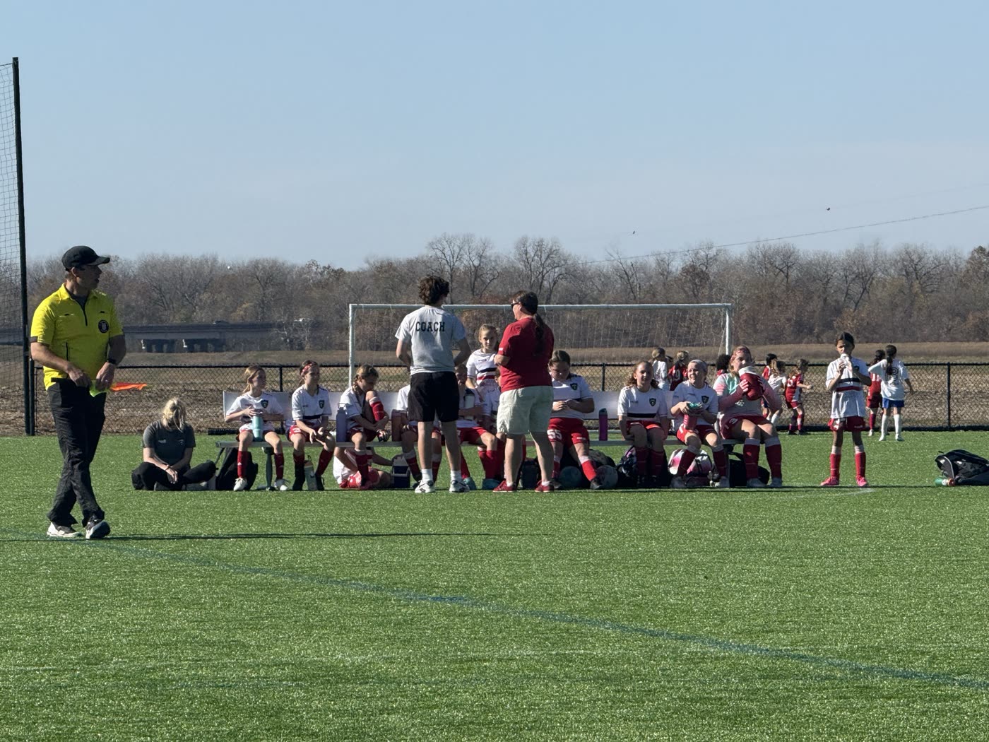 St. Louis Legends players and coaches gather on the sideline during a match